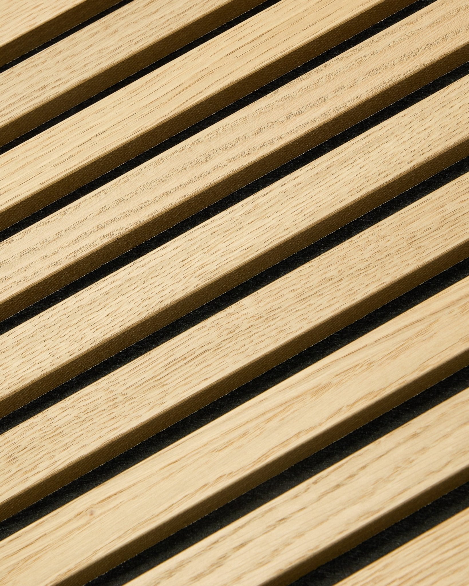 Close-up of WoodUpp Akupixel Classic Oak acoustic panel, 60x60 cm, featuring black felt gaps between oak slats in a striped Nordic design.
