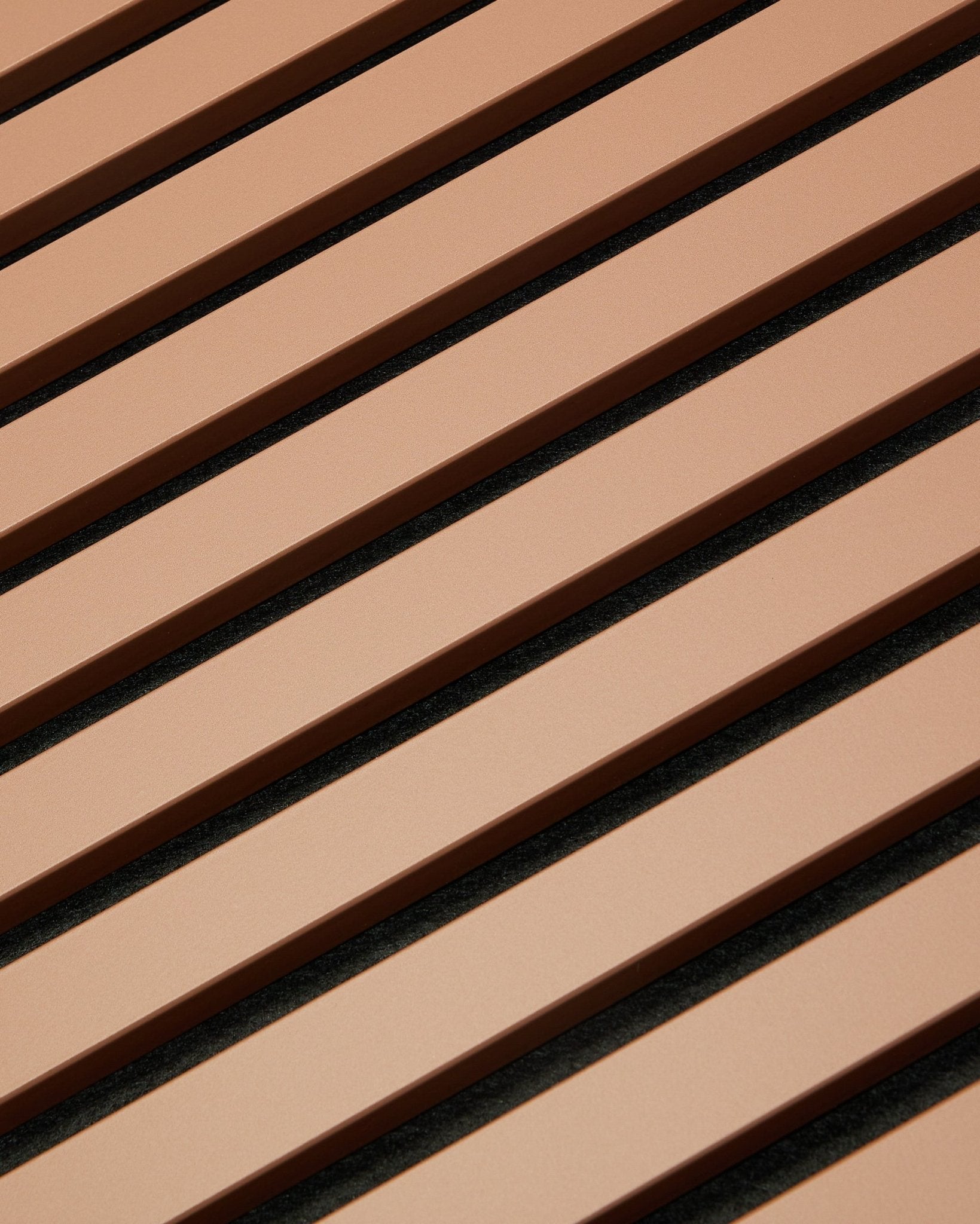 Diagonal brown and black slats form a striped pattern on a 240 x 60 cm Hue | Akupanel / Clay acoustic panel by WoodUpp, reflecting Nordic design.