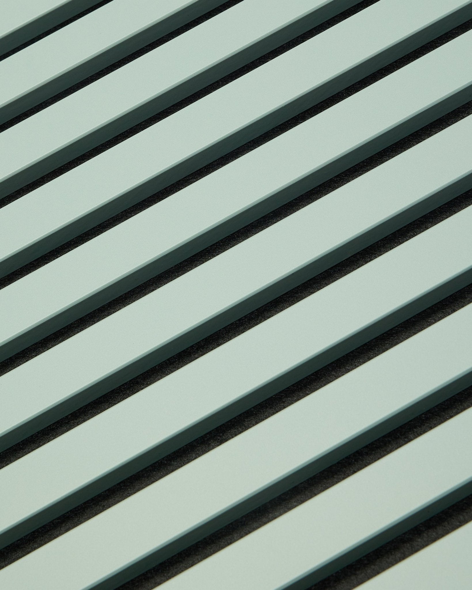 Hue | Akupanel / Cloud by WoodUpp displays light green acoustic wood panels with vertical slats and dark gaps, forming a geometric pattern for sound absorption.