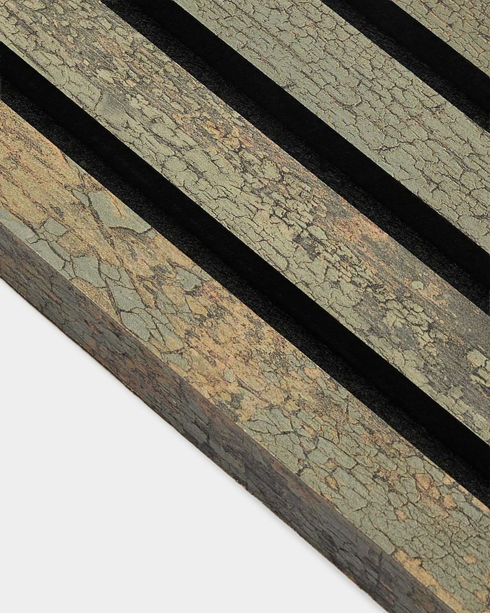 Close-up of WoodUpp Akupanel End Lamella in Oxide Grey, 2.2 cm, showing textured acoustic panel with black grooves on an earthy-toned surface.