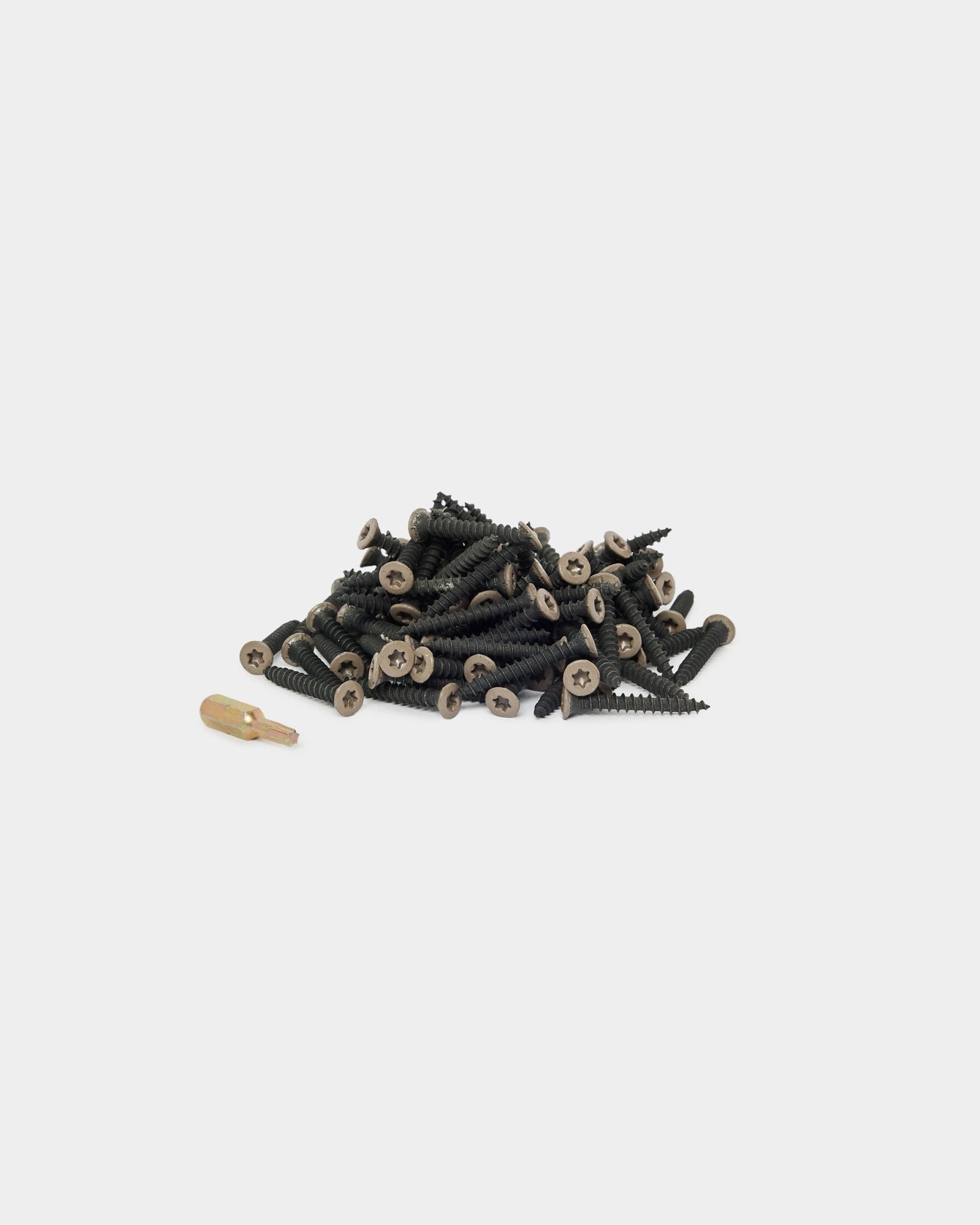 WoodUpp Warm Grey installation screws (100 pcs) and a gold screwdriver bit arranged on a white background, suitable for acoustic panel or panel accessory installation.