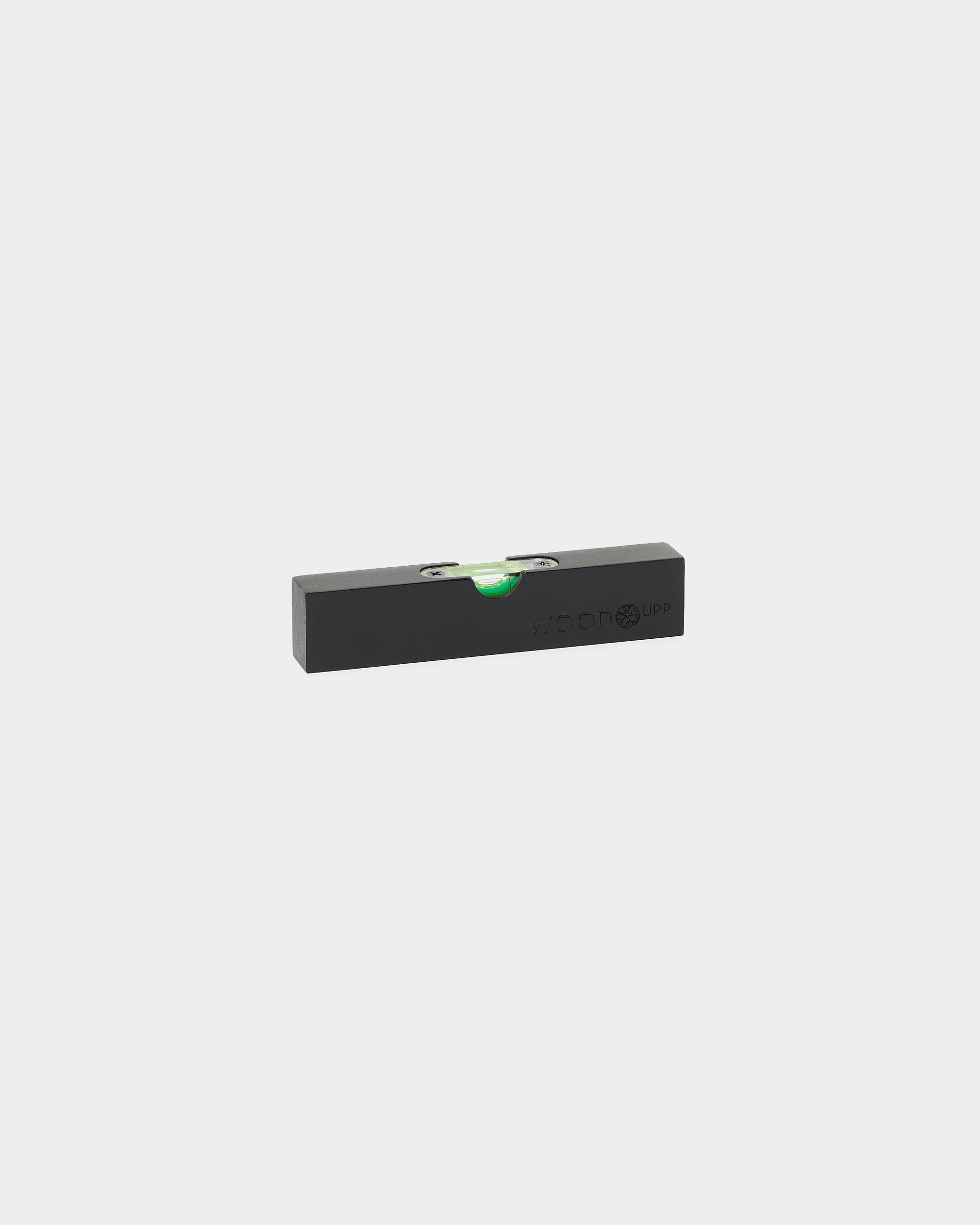 Black WoodUpp Spirit Level (15 x 3.2 cm) with green bubble vial, designed for precise installation of Akupanel or other WoodUpp acoustic panels and accessories.
