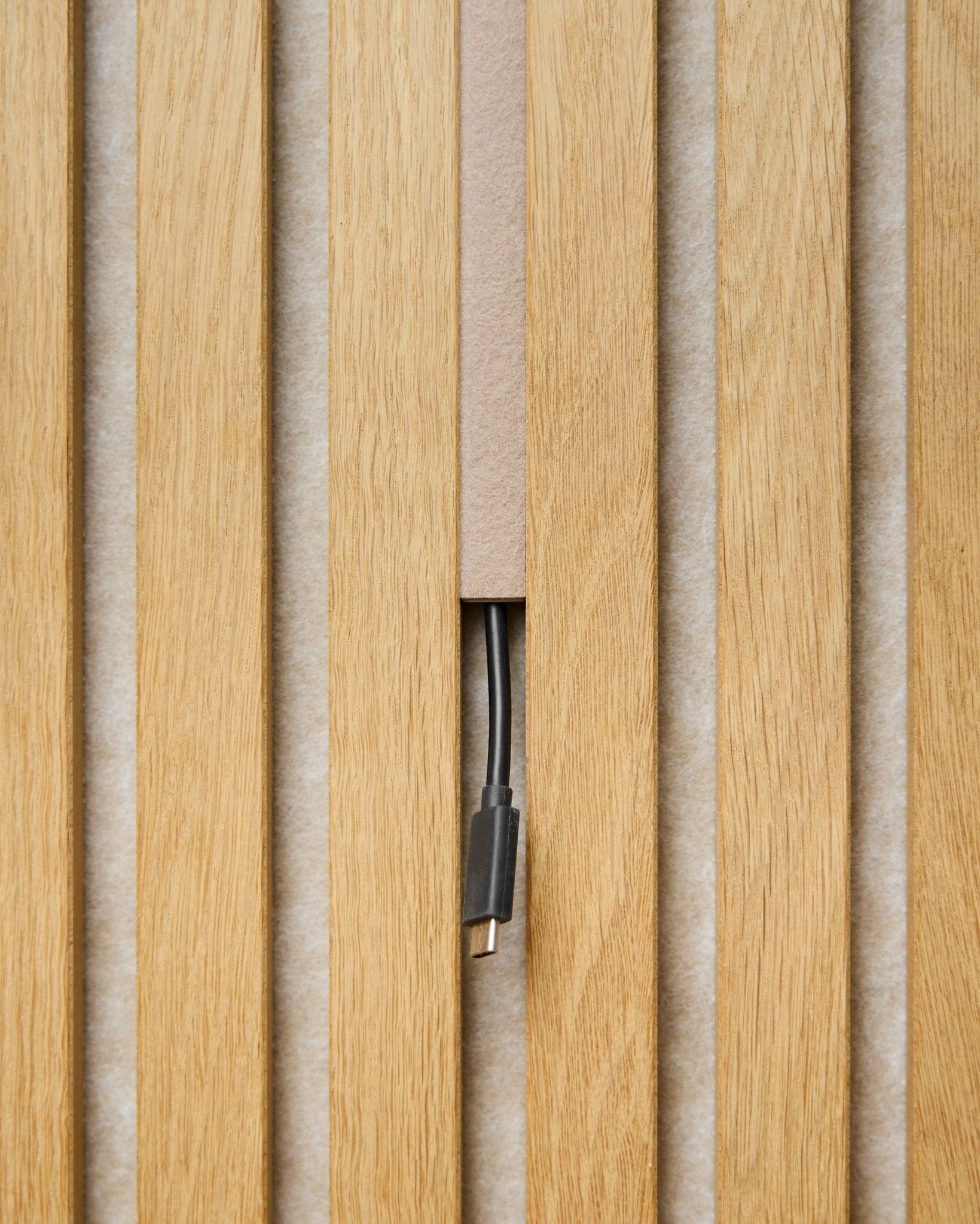 Dupps Pop-on Cable Cover (beige, set of 3) by WoodUpp conceals cables between acoustic panel slats, leaving only the connector visible for a streamlined finish.