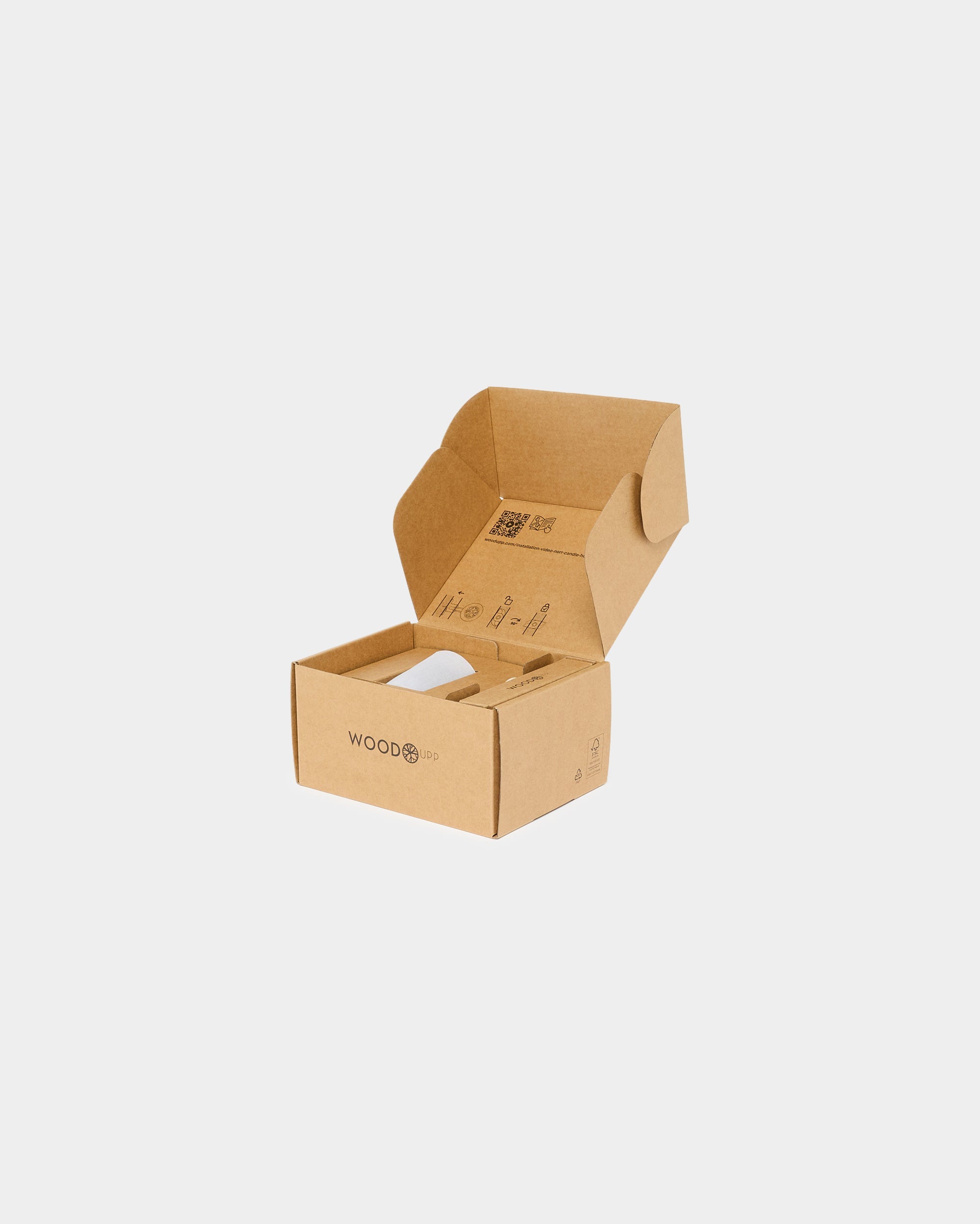 Open brown cardboard box with WOOD logo on a plain white background, its lid open to reveal Nordic acoustic panel materials and eco-friendly packaging inside.