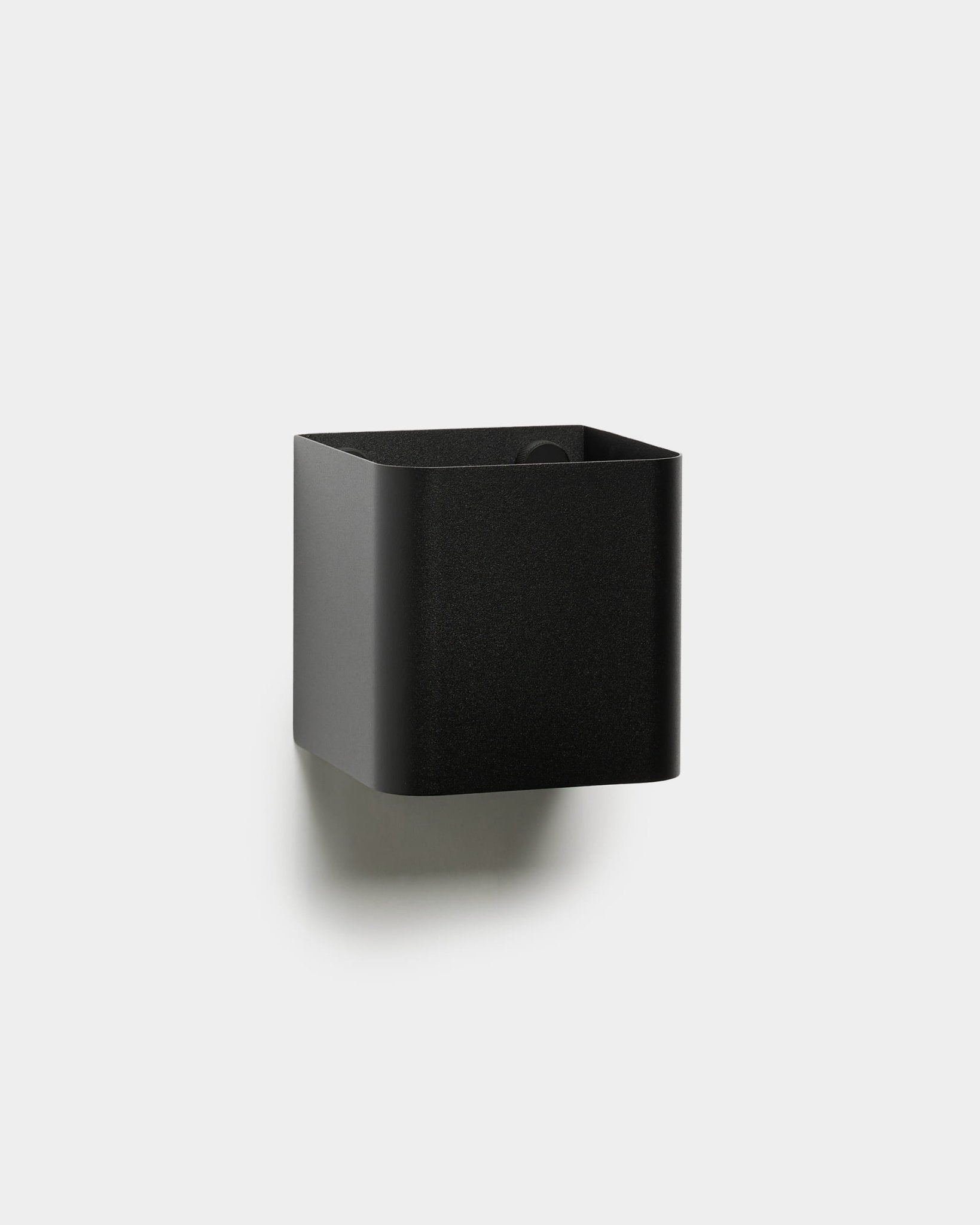 The WoodUpp Norr | Plant Box is a minimalist black square wall-mounted storage container with rounded edges, displayed against a plain white background.