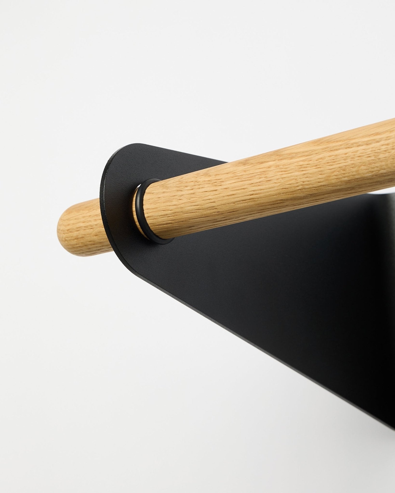 Close-up of the WoodUpp Linn Coat Rail in black (75.9 cm) mounted in a black metal bracket, displayed against a plain white background.