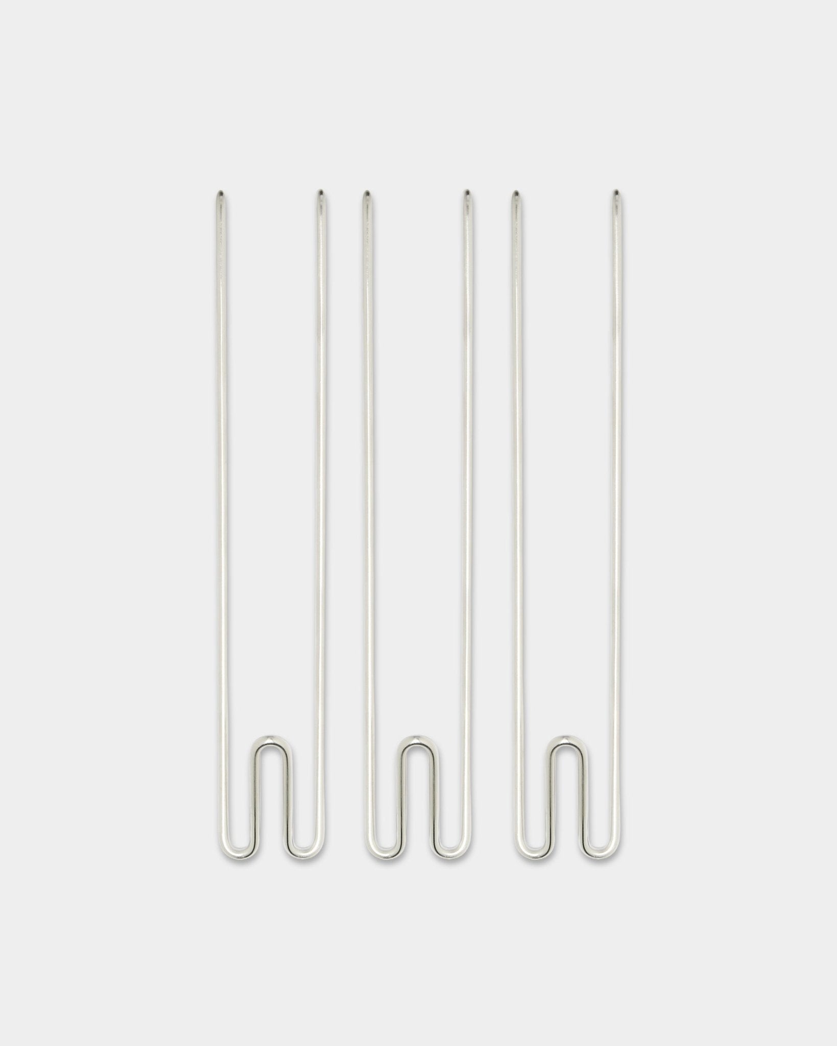Three Alva Wire Hook / BM1 accessories from WoodUpp, long stainless steel hooks arranged vertically on a plain white background.