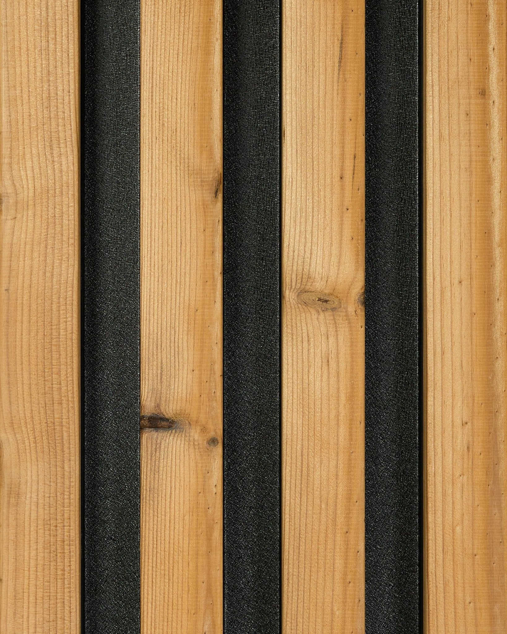Aluwood facade panel sample in brown (45.7 x 27 cm) by WoodUpp, with vertical wood grain planks and black strips creating a modern striped design.