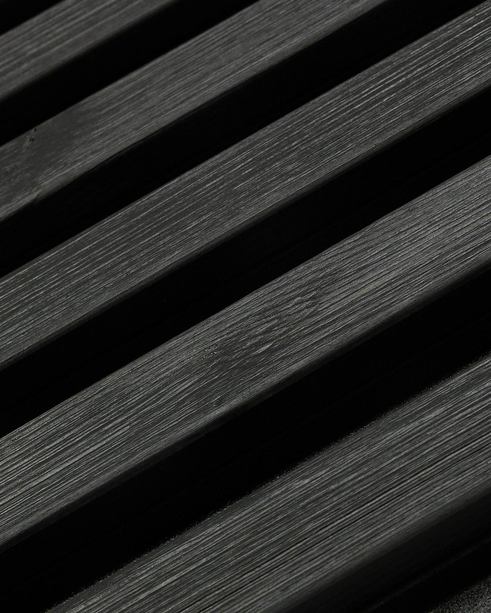 Aluwood outdoor facade panel by WoodUpp, Thermowood in black finish, 240 x 45.1 cm, featuring diagonal Nordic spruce slats with visible grain and shadow.