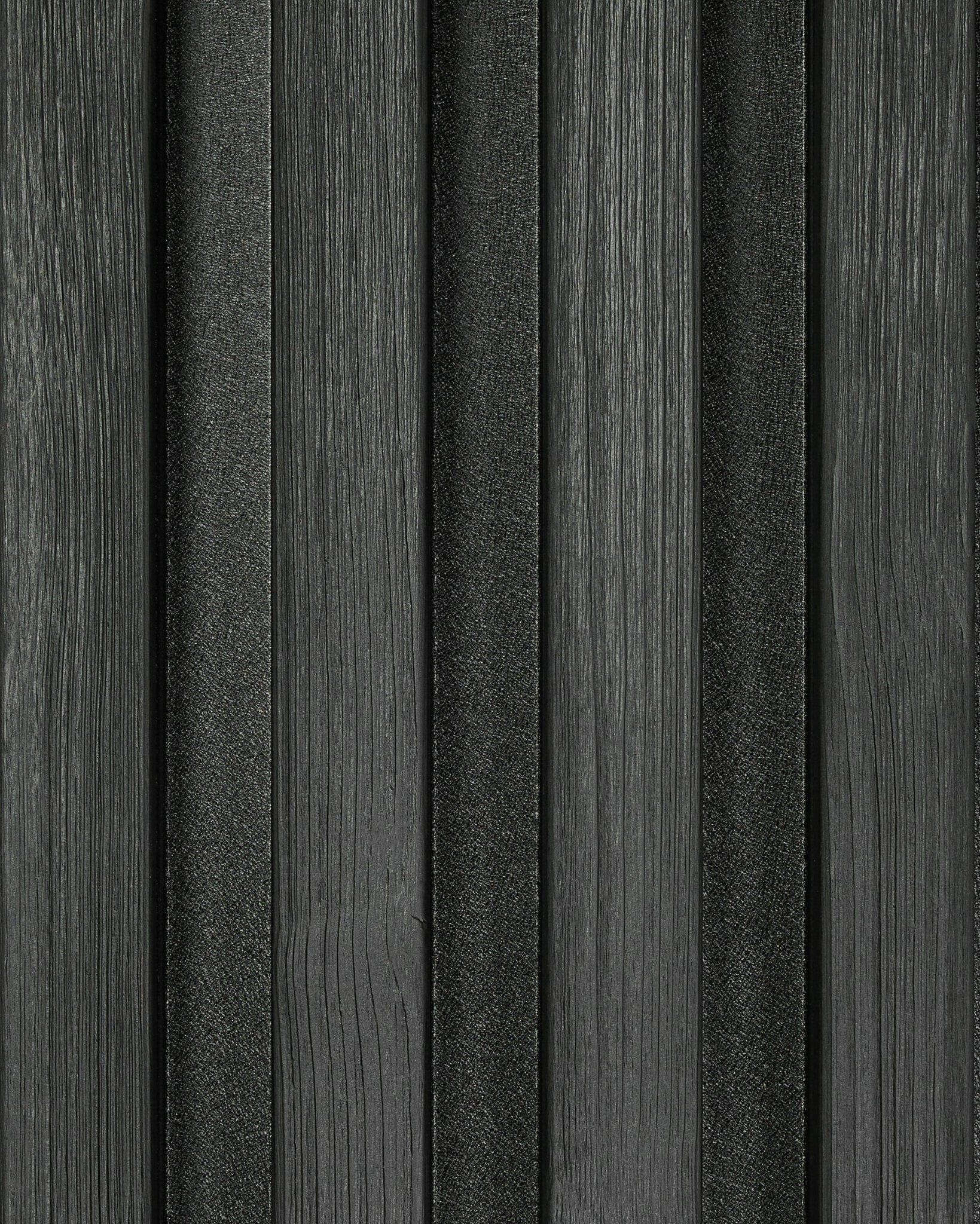 Close-up of Aluwood Black facade panel sample (45.7 x 27 cm) by WoodUpp, showing vertically textured slats with a modern striped pattern.