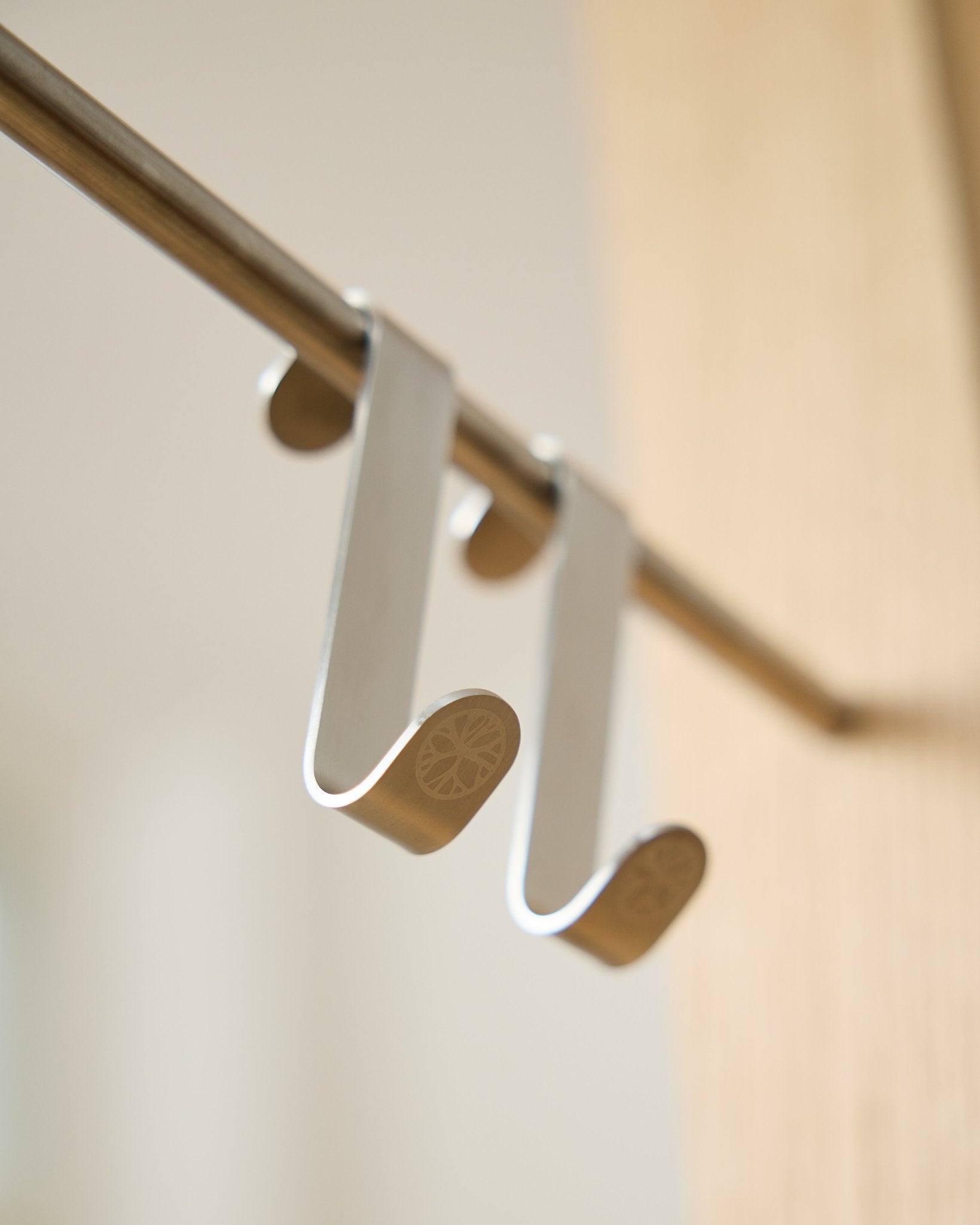 Alva S-Hook BM1  BM2 by WoodUpp, two stainless steel hooks with engraved flat ends, designed for hanging accessories on Akupanel horizontal rods.